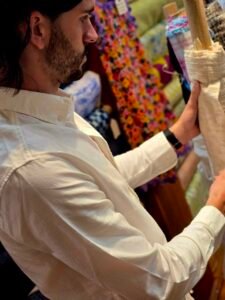 Nick Gallardo examining raw textile material at Global Incentives Manufacturing