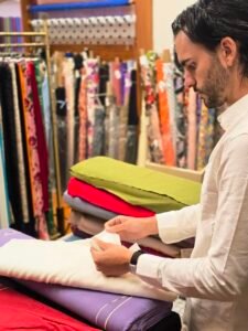 Nick Gallardo examining premium textile fabric at Global Incentives Manufacturing, a Neyius Textiles company.